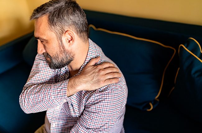 Img_shoulder-impingment Man holding onto sore shoulder